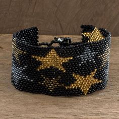 This stylish bracelet is created by the Artisans of Panabaj in Guatemala. The bracelet is crafted from tiny glass beads with gold silver and bronze star motifs on a background of black. It can be fastened at one of three lengths with a crystal button. Star Motif, Crystal Buttons, Buy Bead, Wristband Bracelet, Stylish Bracelet, A Background, Black Star, Bead Crafts, Guatemala