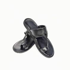 Our modern take on the traditional kohlapuri's, these sandals will work great in any occasion. Our sandals are: 100% high-quality genuine leather handmade by skilled craftsmen. Dual stitching ensures your sandals will last as long as your feet do. Quality leather insole moulds to your feet providing increased comfort with the longer you wear them. Lightweight rubber crepe soles are incredibly resilient, flexible and durable, ensuring equal distribution of the energy from the impact. And they are biodegradable, which makes them super GREEN! COLOR DISCLAIMER There might be a Slight Variation in Color due to Photography / Light effects & also due to computer color resolution. Black Closed Toe Leather Toe Ring Sandals, Black Leather Closed Toe Sandals, Traditional Closed Toe Leather T-strap Sandals, Traditional Leather T-strap Sandals With Closed Toe, Traditional Leather T-strap Closed Toe Sandals, Black Leather Flat Toe Ring Sandals, Black Leather Toe Ring Sandals, Adjustable Black Toe Ring Sandals, Adjustable Black Toe Ring Sandals With Round Toe