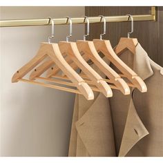 a wooden coat rack with clothes hanging on it