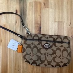 Brand New. Tags On. Retail $78.00. Brown Rectangular Bags With Wrist Strap, Brown Pouch Wristlet For On-the-go, Brown Clutch Wristlet For Everyday Use, Brown Clutch Wristlet, Brown Everyday Clutch Wristlet, Chic Brown Wristlet For Everyday Use, Brown Rectangular Wristlet For On-the-go, Coach Bags With Wrist Strap And Rectangular Shape, Brown Pouch Wristlet For Travel