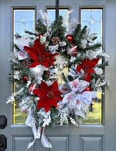 a christmas wreath is hanging on the front door