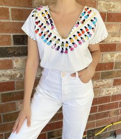 1970's Vintage Mexican hand-embroidered white cotton blouse with dancing women in colourful dresses on the front bodice and embroidered stitch trim, half- sleeve and deep V-neck! One of a kind- Handmade Excellent vintage condition 100% Cotton Measurements taken flat across in inches:  neck: 8.5" shoulders: 20" bust: 20" waist: 19" length: 23" Dance Women, White Cotton Blouse, Vintage Mexican, Cotton Blouses, Half Sleeves, Womens Clothing Tops, Cotton T Shirt, White Cotton, Favorite Outfit