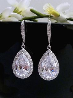 This earring features a tarnish resistant White gold plated metal framed AAA high quality clear white cubic zirconia teardrop, hang from a white gold plated over sterling silver cubic zirconia earwire. Size: 3.8 cm x 1.4 cm or 1.52 x 0.56 inches  I have a matching necklace to this earring: Listing: http://www.etsy.com/listing/101100145/bridal-necklace-high-quality-large-clear GOLD Version is also available. **NOTE: CUBIC ZIRCONIA HAS MANY DIFFERENT GRADES, AND ALL THE CUBIC ZIRCONIA USED IN MY DESIGN IS OF THE HIGHTEST QUALITY. IT SPARKS LIKE DIAMOND AND MUCH PRETTIER IN PERSON)  **Express Shipping available, delivery in about 3 business days , please contact me for rates. **Please see policy: https://www.etsy.com/shop/JCBridalJewelry/policy?ref=shopinfo_policies_leftnav **For more bridal Classy Earrings, Bride Earrings, Wedding Bridal Jewellery, Cz Earrings, Clear White, Gold Plated Bracelets, Antique Earrings, Large Earrings, Bridal Jewelry Sets