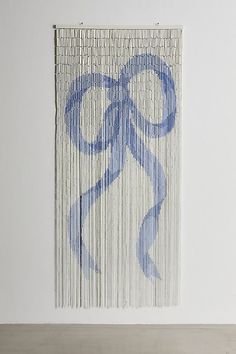 an art piece with blue paint on the side of it and a white wall behind it