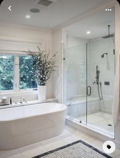 a bathroom with a tub, sink and shower in it's own area is shown