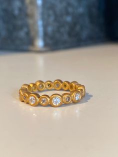 This sparkly eternity band can be made in 22k yellow (see pricing up-charge) or 18k yellow, white or rose gold the larger bezels measure 4.25mm wide. The smaller bezels are 3.25mm wide. Total carat weight of .65 carats of G colored, VS1 clarity diamonds. This ring is a stunner. In size 7 - .47 carats of white diamonds and .18 carats of champagne diamonds. Add $100 for 22k 22k Gold Ring, Round Wedding Band, Interchangeable Earrings, Bubble Earrings, Diamond Stacks, Diamond Mosaic, Gold Engraving, Gold Ring Stack, Silver Wedding Rings