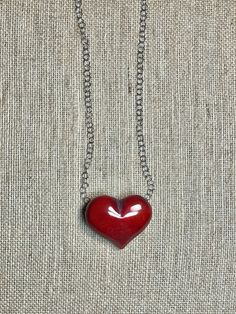 Handmade in Ecuador (Heart 2.5”, .5” thick) Necklace Length: 18 Inches Materials: Tagua, stainless steel chain necklace Due to this item being handmade and the nature of the Tagua Nut the size and the color may vary from piece to piece Red Metal Necklace With Large Pendant, Stainless Steel Jewelry With Large Pendant As Gift, Stainless Steel Large Pendant Jewelry Gift, Heart-shaped Metal Necklace With Soldered Details, Red Large Pendant Jewelry For Gift, Handmade Red Heart-shaped Jewelry, Heart-shaped Sterling Silver Soldered Necklace, Unique Red Heart Shaped Jewelry, Sterling Silver Heart-shaped Soldered Necklaces