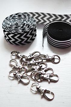 several black and white tapes are next to each other on a table with metal scissors