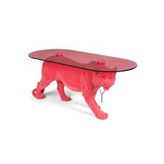 a glass table with a red tiger figurine underneath it