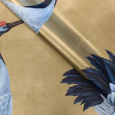 two cranes are standing next to each other on a gold background with black and red accents