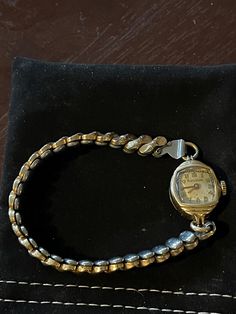 This is a vintage cocktail/dress watch likely from the Lady Bulova line. The serial number (shown) does not give the specific model. More details can be found inside the watch but given it works perfectly, I have no desire to have it cracked open to see. This watch was given to my mother by my father in 1959, and she has been the only owner. It's 14k gold and works perfectly. I don't have any daughters (children or grandchildren) so don't see a reason to hang on to it. I don't have any memories Vintage Yellow Gold Jewelry And Watches For Evening, Vintage Yellow Gold Watch With Jubilee Bracelet, Vintage Formal Jewelry And Watches With 17 Jewels, Vintage White Gold Jewelry And Watches For Formal Occasions, Vintage White Gold Jewelry For Formal Occasions, Vintage Watches With Polished Finish For Evening, Vintage Wedding Jewelry And Watches With Polished Finish, Vintage Gold Watch With Box Clasp, Vintage Yellow Gold Watches For Evening