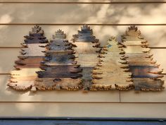 several wooden trees are mounted on the side of a building