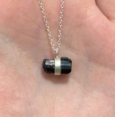 This listing is for one Dainty Black Tourmaline Chunk Necklace. This pendant comes on an adjustable chain that can be worn from 16-22 inches. Black Tourmaline is an opaque stone that is black in hue. It is typically found with vertical striations within the formation. This stone is never transparent or translucent unlike other forms of Tourmaline. Black Tourmaline is also known as Schorl. Black Tourmaline is electrical in nature and it provides a connection between Earth and spirit. It helps one Adjustable Sterling Silver Crystal Necklace, Spiritual Tourmaline Jewelry As A Gift, Spiritual Tourmaline Jewelry Gift, Silver Tourmaline Jewelry Gift, Adjustable Silver Tourmaline Jewelry, Silver Tourmaline Adjustable Jewelry, Chunk Necklace, Spiritual Tourmaline Silver Jewelry, Black Tourmaline Jewelry As Gift