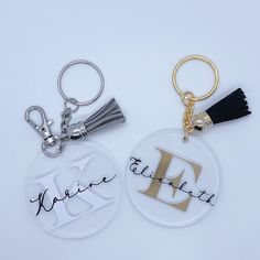 two personalized key chains with the letters d and f on them, one has a tassel