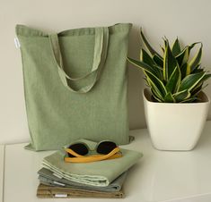 ◦ Eco-friendly naturally dyed cotton tote bag in green tones.   Every item was hand dyed using only natural plant dyes.    You may choose the tone you like better.  Currently three are available: Green light_1, Green_2, Green dark_3, Olive-green_4 ◦ These bags are a great option for shopping or everyday use and can be a thoughtful practical gift for a person appreciating all natural.   Soft and subtle colors will look nice with casual natural clothing.  ◦ Size: 35cm (13.8 inch) x 38cm (15inch), Green Cotton Canvas Bag For Everyday Use, Green Cotton Canvas Bag For Everyday, Green Cotton Bags For Summer, Green Cotton Tote Bags, Green Reusable Everyday Canvas Bag, Everyday Green Reusable Canvas Bag, Green Reusable Canvas Bag For Everyday, Green Eco-friendly Canvas Bag, Eco-friendly Green Canvas Bag