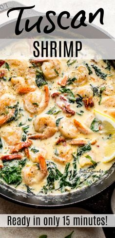 a skillet with shrimp and spinach in it, next to lemon wedges