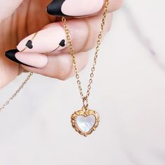 LOVE SHELL NECKLACE: ✦ Small convex heart necklace engraved on both sides and set with white mother of pearl  COMPOSITION: ✦ Gold plated 18K stainless steel ✦ White mother of pearl SIZE: ✦ Pendant: 1.2 x 1.2 cm ✦ Chain lenght: 40 cm + 5 cm extension JEWELLRY CARE: ✦ This jewel is made of stainless steel which makes it tarnish resistant and waterproof. Over time, the golden layer can acquire a slight patina.  In order to keep your jewel as the first day, it is recommended to remove it regularly f White Heart Necklace With Clavicle Chain As Gift, White Heart Clavicle Chain Necklace As Gift, White Stainless Steel Jewelry With Heart Charm, White Stainless Steel Heart Pendant Jewelry, White Stainless Steel Necklace For Gift, White Metal Heart Necklace With Heart Charm, White Stainless Steel Necklaces For Mother's Day, White Metal Heart Necklace For Valentine's Day, Engraved Mother Of Pearl Necklaces For Gifts