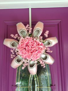 a purple door with pink flowers and ballet shoes