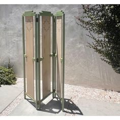 an outdoor room divider made out of wood and metal with two doors on each side