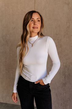 Embrace classic style with the Maren Ribbed Long Sleeve Top. Made from soft ribbed fabric, this top offers both comfort and sophistication. The high neckline adds a touch of elegance, while the long sleeves ensure you stay warm and stylish. Available in black, grey, and white, the Maren top is a versatile essential that pairs effortlessly with any bottom, making it perfect for layering or wearing solo. Elevate your wardrobe with this timeless piece that effortlessly combines form and function. Chic Ribbed Fitted Mock Neck Top, Chic Ribbed Mock Neck Top, Chic Ribbed Turtleneck Tops, Chic Ribbed High Neck Top, Ribbed Fitted Long Sleeve Top, Solid Ribbed Fitted Long Sleeve Top, Chic High Neck Ribbed Tops, Chic Ribbed Long Sleeve Top With Stretch, Chic Ribbed Funnel Neck Top