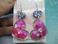 These fun earrings are handmade with lots of sparkly glitter encased in resin. Add some sweet sparkle to your day. The hooks are nickel free silver. (due to the handmade nature each pair will differ slightly)Condition: Brand New and Unworn Orchid Necklace, Diy Resin Projects, Pink Party, Pink Parties, Earrings Statement, Dangle Charms, Fun Earrings, Heart Earrings, Resin Crafts