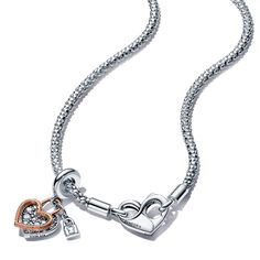 When hearts collide. From Pandora, this romantic set includes a sterling silver studded chain necklace with a flexible, textured chain and an infinity-detailed openable heart clasp that can be styled with up to 4-6 charms or dangle charms. Style it with your favorite charms and any size of Pandora O Pendants. It comes with a heart-shaped double dangle charm features an open heart silhouette in 14k rose gold plating, outlining a sterling silver pave heart. It is decorated with a tiny padlock, ins Silver Charm Necklaces In Fine Jewelry Style, Elegant Sterling Silver Charms With Removable Features, Elegant Sterling Silver Charms With Removable Details, Elegant Silver Charms With Dangling Details, Anniversary Jewelry With Removable Heart Charms, Sterling Silver Heart Jewelry With Removable Charms, Sterling Silver Heart-shaped Jewelry With Removable Charms, Silver Heart Necklace With Removable Charms, Elegant Heart Pendant Jewelry With Removable Charms