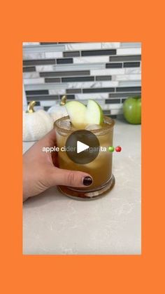 an apple cider is being served in a glass