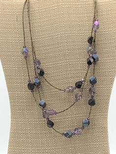 Multi strand purple beads necklace by Lia Sophia Adjustable Purple Beaded Necklace With Dangling Beads, Purple Beaded Chain Necklace With Round Beads, Elegant Purple Beaded Necklace With Dangling Beads, Purple Multi-strand Beaded Necklace, Elegant Multi-strand Purple Beaded Necklaces, Purple Beaded Chain For Jewelry Making, Elegant Purple Multi-strand Beaded Necklaces, Purple Beaded Necklace With Round Black Beads, Adjustable Purple Necklace With Dangling Beads