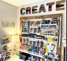 a craft room with lots of craft supplies on the wall and shelves filled with crayons