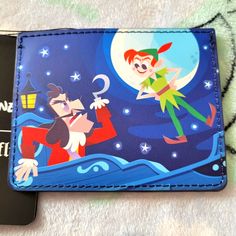 Loungefly Disney Peter Pan Card Holder. It Has Slots For Credit Cards And A Pocket For Bills And Coins. Disney Card Holder, Disney Card, Lounge Fly, Pan Card, Disney Cards, Disney Bags, Loungefly Bag, Disney Bag, Loungefly Disney