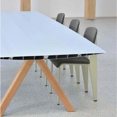 a white table with four chairs around it