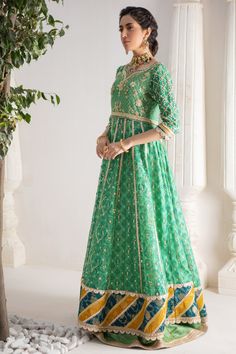 Make a colorful style statement with our beautifully crafted ensemble, gorgeous hand block printed kalidar, heavily embellished with sequins, beads and gota boti chan, neckline and sleeves are beautifully adorned with gorgeous zardozi work, stunning teal & Dhani green hued chata pati appliquéd border on hem finishes it beautifully, gorgeous detailed back and hand-made tassels gives entire outfit a trendy element. This stunning kalidar is offset with jamawar Lehanga and gorgeous Maysuri dupatta featuring gota motifs and heavily embellished chan, trimmed with gota borders , a Must- have wardrobe staple to carry all Wedding Festivities in effortless style. Kalidar Fabric: Pure Silk Net Lehanga Fabric: Jamawar Dupatta Fabric: Pure Maysuri Outfit Color: Opal This outfit is only available in Cus Dabka Work Anarkali Set For Reception, Dola Silk Kurta With Mirror Work For Reception, Reception Dola Silk Kurta With Mirror Work, Traditional Straight Kurta With Mirror Work For Reception, Anarkali Traditional Wear With Dabka Work For Reception, Anarkali Set With Dabka Work For Reception, Reception Chinon Kurta With Dabka Work, Festival Anarkali Set With Dabka Work For Reception, Green Resham Embroidered Anarkali Set In Mulmul