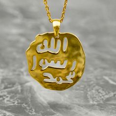 Crafted with exquisite detail and profound symbolism, the Seal of Prophet Muhammad Necklace is a timeless piece of Islamic jewelry that holds deep significance. Made from 925 sterling silver elegantly plated with 18K gold, this necklace radiates elegance and beauty. The intricate design featuring Arabic calligraphy of the Seal of Prophet Muhammad brings a touch of spirituality and tradition. Perfect for a birthday gift, anniversary present, or simply to show appreciation to a loved one, this nec Spiritual Gold-plated Engraved Necklaces, Amulet Style Yellow Gold Sterling Silver Coin Necklace, Amulet Sterling Silver Coin Necklace In Yellow Gold, Spiritual Engraved Gold-plated Necklaces, Spiritual Engraved Gold Plated Necklaces, Sterling Silver Medallion For Blessing Occasion, Yellow Gold Pendant Jewelry For Blessing, Symbolic Gold-plated Medallion Necklace, Symbolic Gold Plated Medallion Necklace