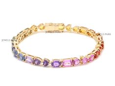 Rainbow sapphire emerald cut mix shape tennis bracelet gold | Natural 4MM wide multi sapphire tennis bracelet gold | Rainbow bracelet gold STONE DETAILS : ✦ Gemstone: Rainbow Sapphire ✦ Gemstone Type : Natural ✦ Gemstone Size : 6x4MM ✦ Gemstone Shape : Oval, Pear, Heart, Oval ✦ Number of gemstones : 28 ✦ Gemstone Weight : 15 Carats ✦ Gemstone Grade : AAAA METAL DETAILS : ✦ Metal : 14K/18K Gold ✦ Metal Color : Yellow / White / Rose Gold ✦ Setting : Prong Setting ✦ Bracelet Box : Yes SHIPPING DETAILS : ✦ Shipped via ; USPS ✦ Production time : 10-12 days ✦ Delivery time : 7-8 days ✦ Expedited shipping : Available ✦ Expedited shipping service : UPS ✦ Expedited shipping time : 5 days ✦ Expedited shipping cost : 70$ CUSTOMISATION DETAILS : We can customize any piece of fine jewelry. You can simp Gold Multi-stone Tennis Bracelet, Tennis Bracelet Gold, Sapphire Tennis Bracelet, Dress Reference, Armband Gold, Rainbow Sapphires, Bracelet Box, Multi Sapphire, Rainbow Bracelet