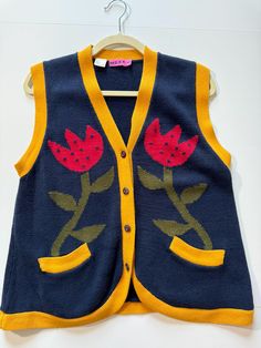 Appears to be vintage from the 80s or 90s. Couldn't find any deeper details on this brand or this vest. This vibrant v-neck button up style tulip vest will take your breath away. Great tonal colorway. Super soft feel! Excellent vintage condition with zero flaws. 100% cotton. Nice quality buttons. Also 2 full functioning waist pockets (not faux). Retro V-neck Vest For Spring, Retro V-neck Fitted Vest, Retro V-neck Winter Vest, Vintage Cotton Summer Cardigan, Vintage Cotton Cardigan For Summer, Vintage V-neck Vest For Spring, Retro Cotton Vest With Buttons, Cotton V-neck Vest With Button Closure, Vintage Sleeveless Vest With Button Closure