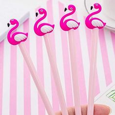 three pink flamingos are sitting on top of some straws in the shape of animals