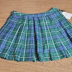 Forever 21 Plaid Skirt Green, Blue, White, And Black Pleated No Stretch New With Tags, And Extra Button 100% Polyester Size- Medium Approximate Measurements (Laid Out Flat): Waist- 12.5" Length- 15" Preppy School Skirt Bottoms, Preppy Pleated Mini Skirt, Preppy Short School Skirt, High Waist Cotton Mini Skirt In Preppy Style, Preppy High Waist Cotton Mini Skirt, Preppy High-waist Cotton Mini Skirt, Green Lined Skirt Bottoms For School, Preppy Green Pleated Skirt, Green Pleated Preppy Skirt