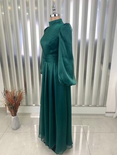 Made from 100% organza chiffon fabric.  product weight is 550 grams.  It is a lined dress.  It is 152 centimeters long. Chiffon A-line Maxi Dress For Wedding, Green Organza Gown For Banquet, Green Organza Gown For Banquets, Green Chiffon Evening Dress, Green Organza Evening Dress For Banquet, Organza Dress With Sheer Long Sleeves, Green Floor-length Organza Evening Dress, Long Sleeve Organza Dress With Sheer Sleeves, Long Sleeve Chiffon Dress For Wedding