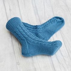 These socks are so comfortable you'll want to wear them all year long. Our hand knit socks provide a higher quality of craftsmanship, which means you can enjoy them year round, year after year. Never again will you leave the comfort of your warm bed to be awoken by an ice cold floor beneath your feet. Cuddling up with a blanket in front of the television will no longer be a choice of warm feet or warm shoulders.  You'll no longer need a space heater beneath the desk in your freezing office. Warm Comfortable Knitted Winter Socks, Comfortable Hand Knitted Winter Socks, Comfortable Thick Knitted Socks, Handmade Cozy Winter Socks, Cozy Chunky Knit Socks, Cozy Chunky Knit Socks With Round Toe, Casual Comfortable Hand Knitted Socks, Comfortable Blue Knitted Socks, Thick Knitted Socks