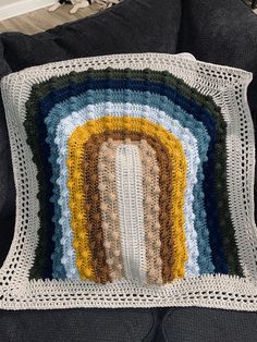 a crocheted granny's afghan on a couch