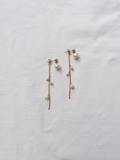 These earrings can be worn in 2 ways - as a backdrop with the long chain adorned with small freshwatwer pearls or just as a pearl droplets (you will recieve one extra back closure for secure wear) Made from genuine freshwater pearls and PVD gold plated stainless steel - tarnish resitant gold plating - you can wear your jewelry every day and it will remain gold (even when it comes in touch with water) Total lenght: 7 cm = 2.8" Can be made also in silver version (stainless steel) You will recieve Long Drop Pearl Bridal Earrings With Pearl Chain, Long Drop Pearl Earrings With Dangling Beads For Wedding, Bridal Long Drop Pearl Earrings With Pearl Chain, Wedding Long Drop Pearl Earrings With Dangling Beads, Delicate Long Drop Linear Earrings With Pearl Charm, White Pearl Drop Backdrop Necklace, Long Drop Pearl Chain Bridal Earrings, Wedding Linear Dangling Bead Earrings, Wedding Linear Dangle Earrings With Beads