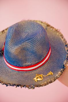 Sail into the summer with our BON VOYAGE SUN HAT! This stylish blue and gold hat features a bold red and white striped ribbon band and a playful gold sailboat pin. Finished with a patriotic red, white, and blue feather combo, it's perfect for any beach day or boat trip. This hat is ONE OF A KIND, created by our owner Stephanie. To receive item quicker, expedited shipping is available at checkout. Gold Hat, Gold Hats, Boat Trip, Striped Ribbon, Blue Feather, Boat Trips, Blue And Gold, Sun Hat, Red White And Blue