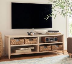 a flat screen tv mounted to the side of a wooden entertainment center in a living room