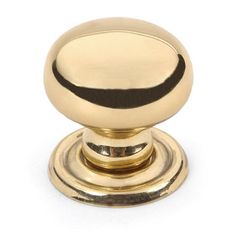 an antique brass knob with black stripe on the top and bottom, is shown in this image