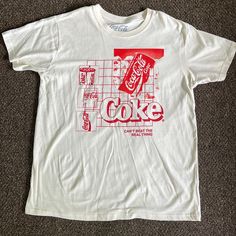 Brand New And Never Worn! Cream And Red Coca-Cola T-Shirt. No Rips Or Stains! Size: L 90s Red T-shirt With Text Print, Casual Red Tops With Graphic Print, Casual Red Top With Graphic Print, Red Casual T-shirt With Graphic Design, 90s Style Red T-shirt With Text Print, Casual Crew Neck Shirt With Graphic Design, Casual Red Tops With Graphic Design, Casual Red Shirt With Graphic Print, Coca Cola Shirt