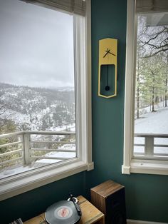 a record player sitting on top of a table next to a window