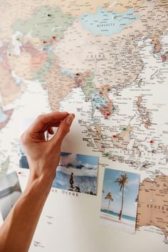 a person pointing at a map with pictures on it