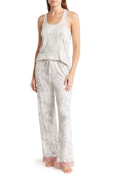 Lounge in ultimate comfort in this super soft scoop neck tank and pajama bottoms set. 2-piece set Top: 24" length; Pants: 13" rise, 29" inseam (size S) Top: scoop neck, sleeveless, racerback, knit construction, lace trim Bottoms: elasticized drawstring waist, pull-on style, knit construction, lace trim 95% rayon, 5% spandex Machine wash Imported Model’s stats for sizing: 5’11” height, 32” bust, 24” waist, 34” hips. Model is wearing size S. Sleeveless Tops With Elastic Waistband For Loungewear, Sleeveless Relaxed Fit Sleepwear For Bedtime, Sleeveless Relaxed Fit Sleepwear, Relaxed Fit Sleeveless Sleepwear, Relaxed White Tank Top For Loungewear, White Relaxed Fit Tank Top For Loungewear, Pajama Bottoms, Honeydew, Grey Stripes