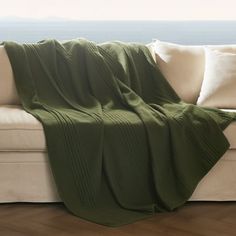 a couch with a green blanket on top of it