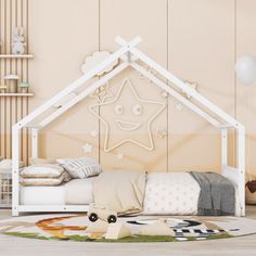 a child's room with a white bed and star shaped decoration on the wall